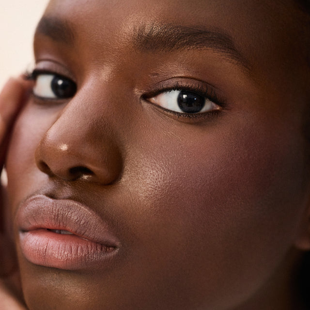 Deep skin tone model wearing Impressionist Multistick in Intuition