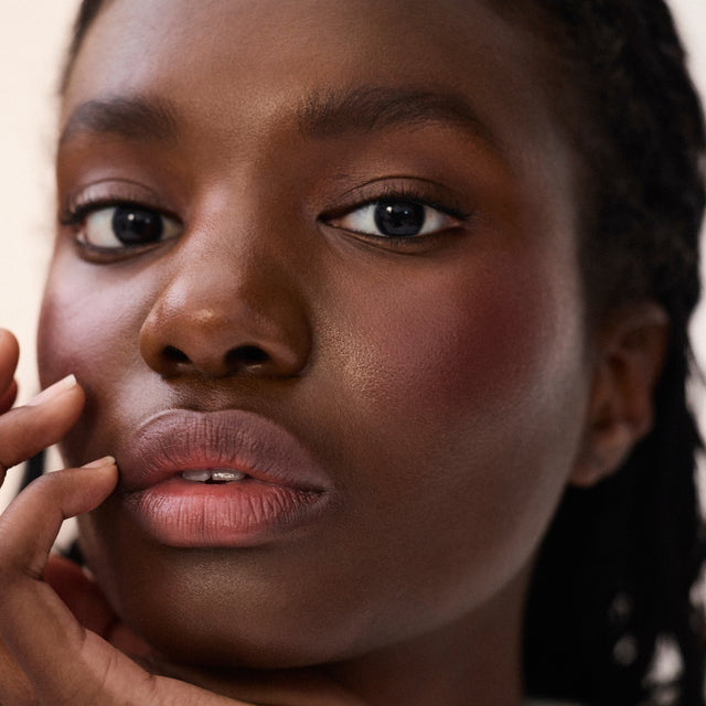 Deep skin tone model wearing Impressionist Multistick in Muse