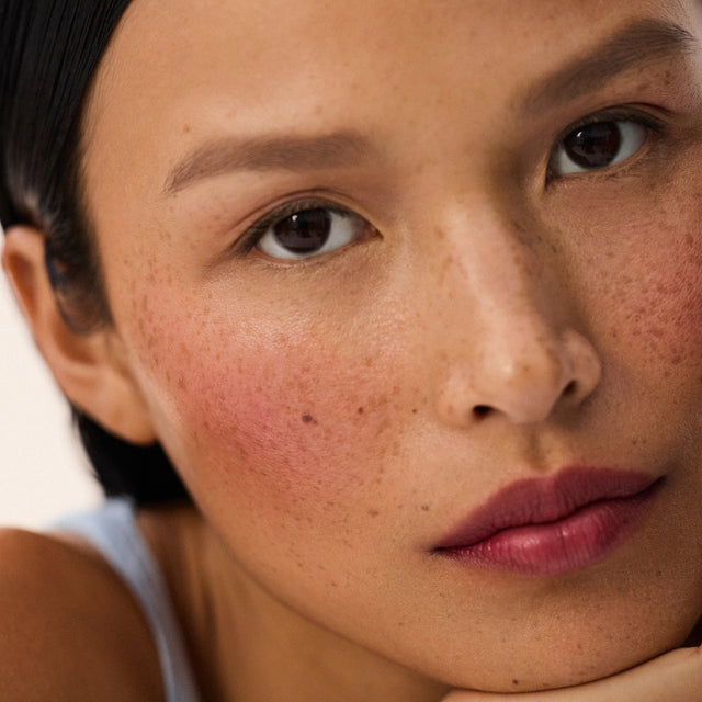 Medium skin tone model wearing Impressionist Multistick in Ripe