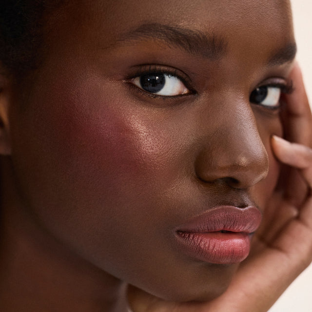 Deep skin tone model wearing Impressionist Multistick in Vibration